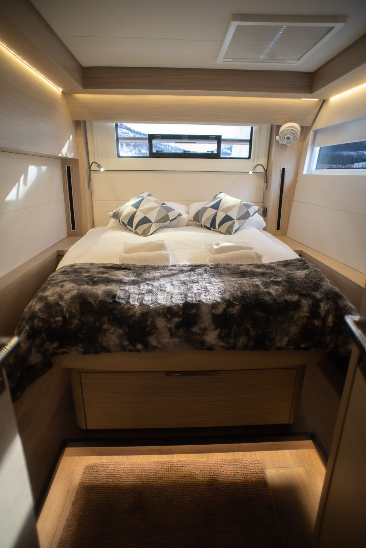 Forward double cabin with panoramic window onto a snowy fjord