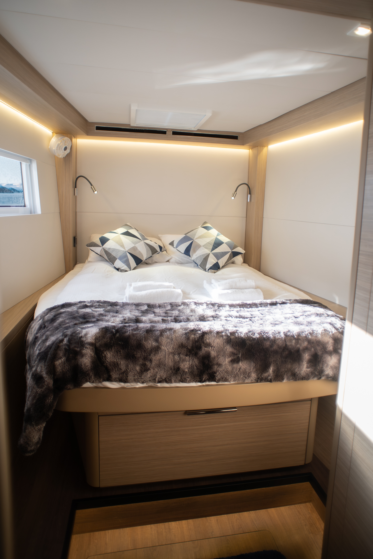 Guest double cabin with faux fur throw and reading lights