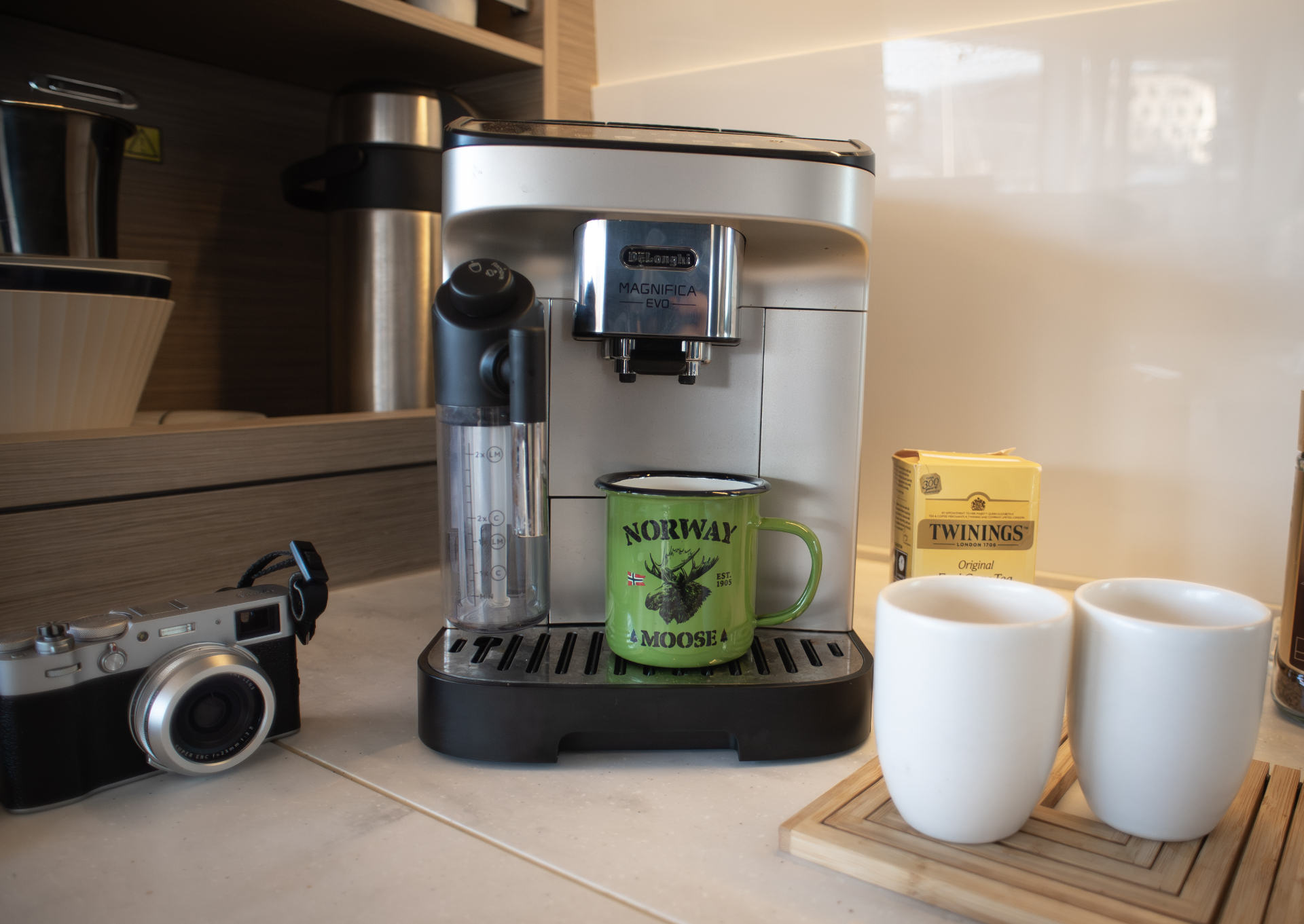 De'Longhi bean-to-cup espresso machine on the galley counter with Norwegian enamel mug